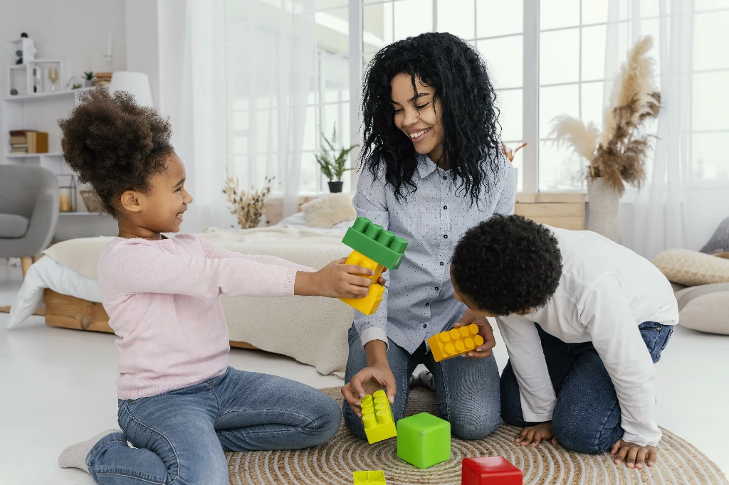 front-view-happy-mother-playing-home-with-her-children~1